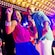 A couple dances under bright lights in an onboard nightclub